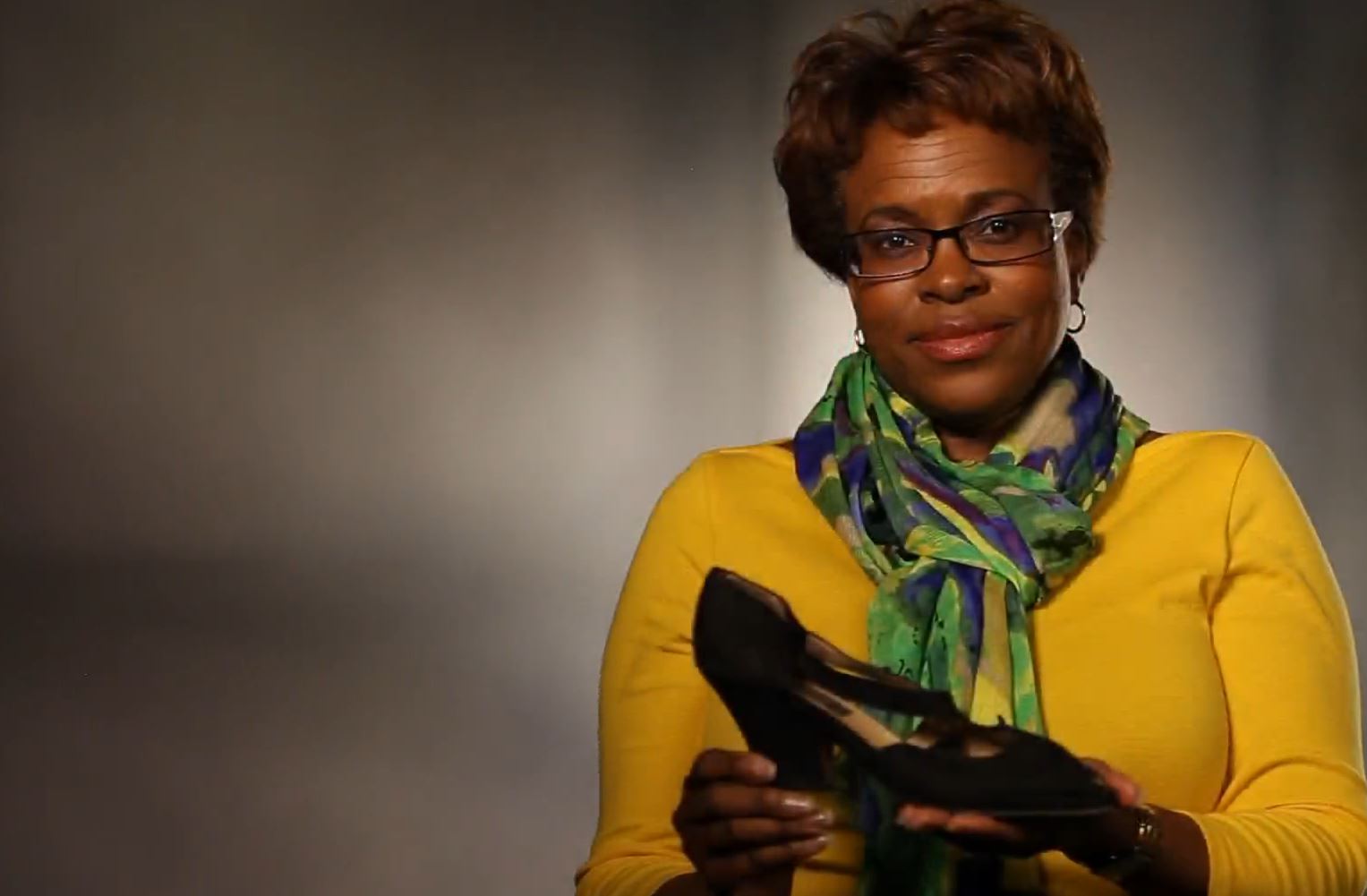 9/11 survivor Florence Jones holds up the shoes she wore on 9/11.