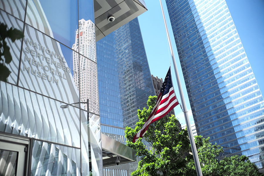 An American flag flies at half-staff outside the 9/11 Memorial Museum in observance of the victims of the Pulse nightclub shooting in Orlando, Florida.