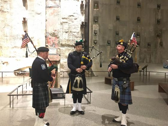 FDNY officer Bob King, NYPD officer Eamon Nugent and PAPD officer Brian Ahern wear kilts as they take part in the weekly bagpipe tribute in Foundation Hall.