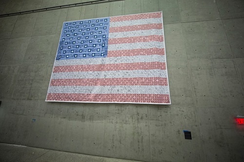 Mindy Kombert and Sherry Kronenfeld’s “Flag of Remembrance” is seen installed on a wall at the Museum. The the 20-foot-by-27-foot piece is composed of individual images of the victims of the attacks.