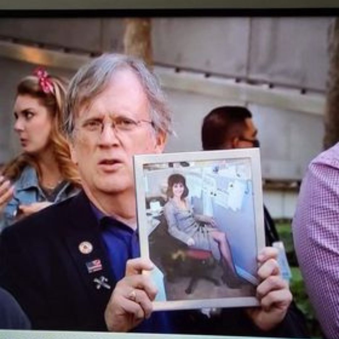 John Quinn with a photo of his friend Joyce Capeneto