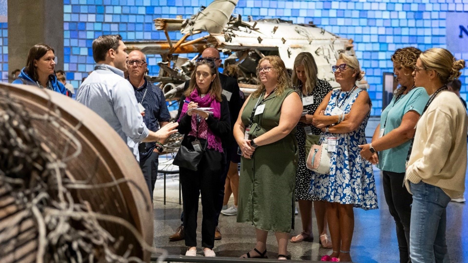 A group of educators listen to a tour guide in front of the Spencer Finch installation at the Museum