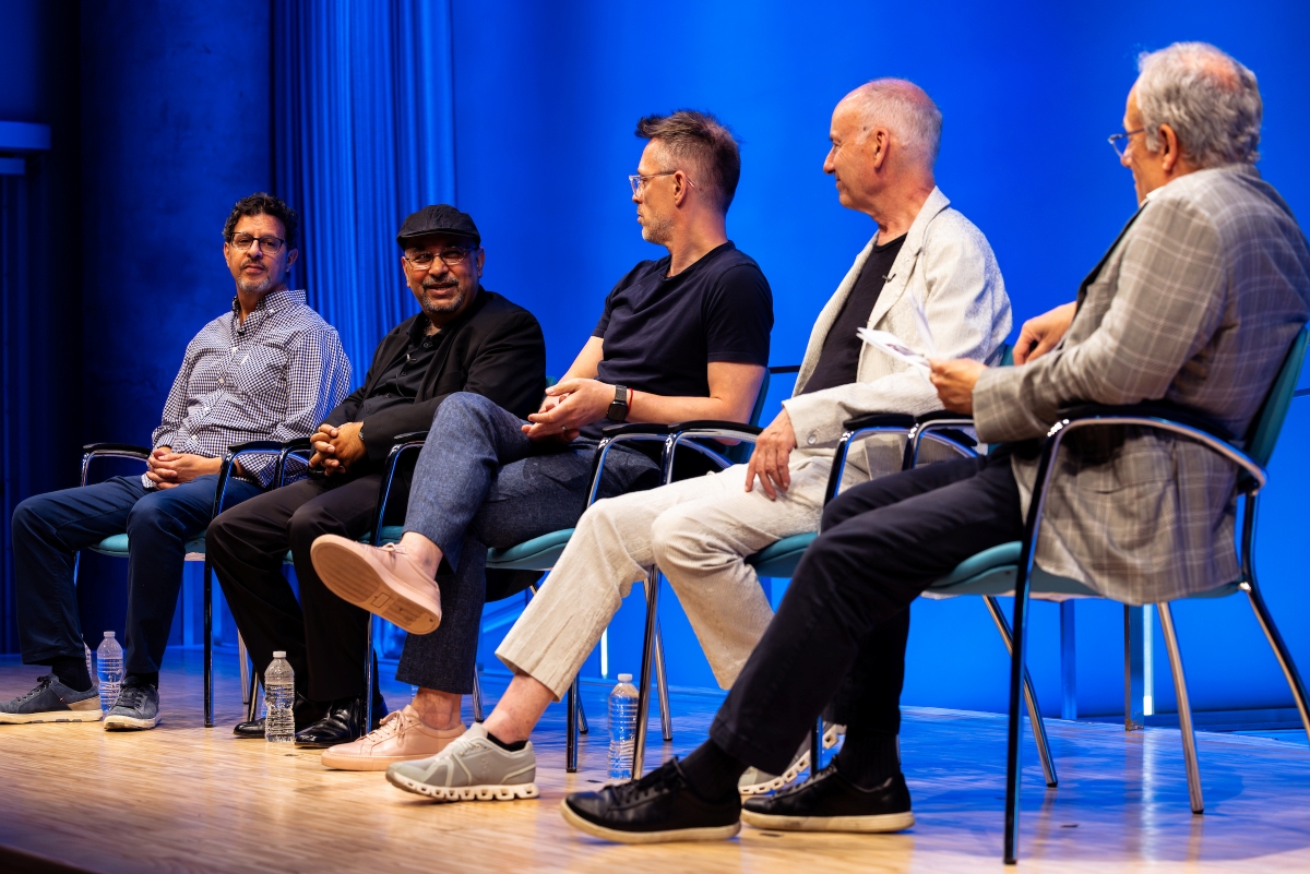 Panelists on stage talk during Battery Dance