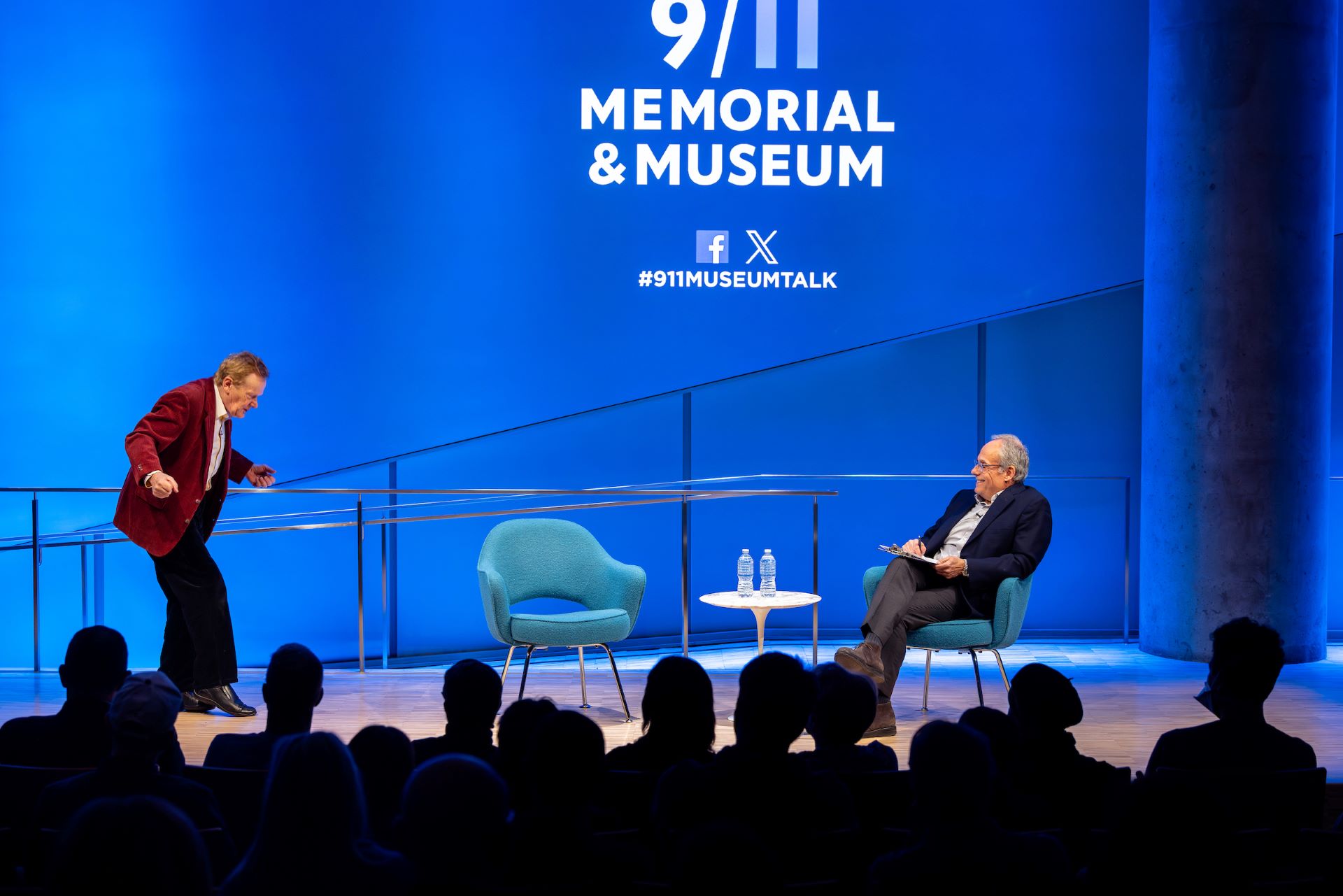 Philippe Petit and Clifford Channing on the stage; Philippe Petit imitates wire walking as the audience watches