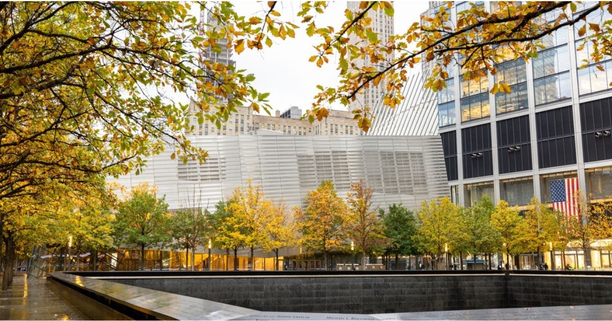 Leaves changing color along the 9/11 Memorial, with the Museum in the background