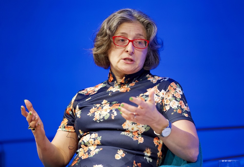 A close-up photo of a public program participant gesturing with her hands.