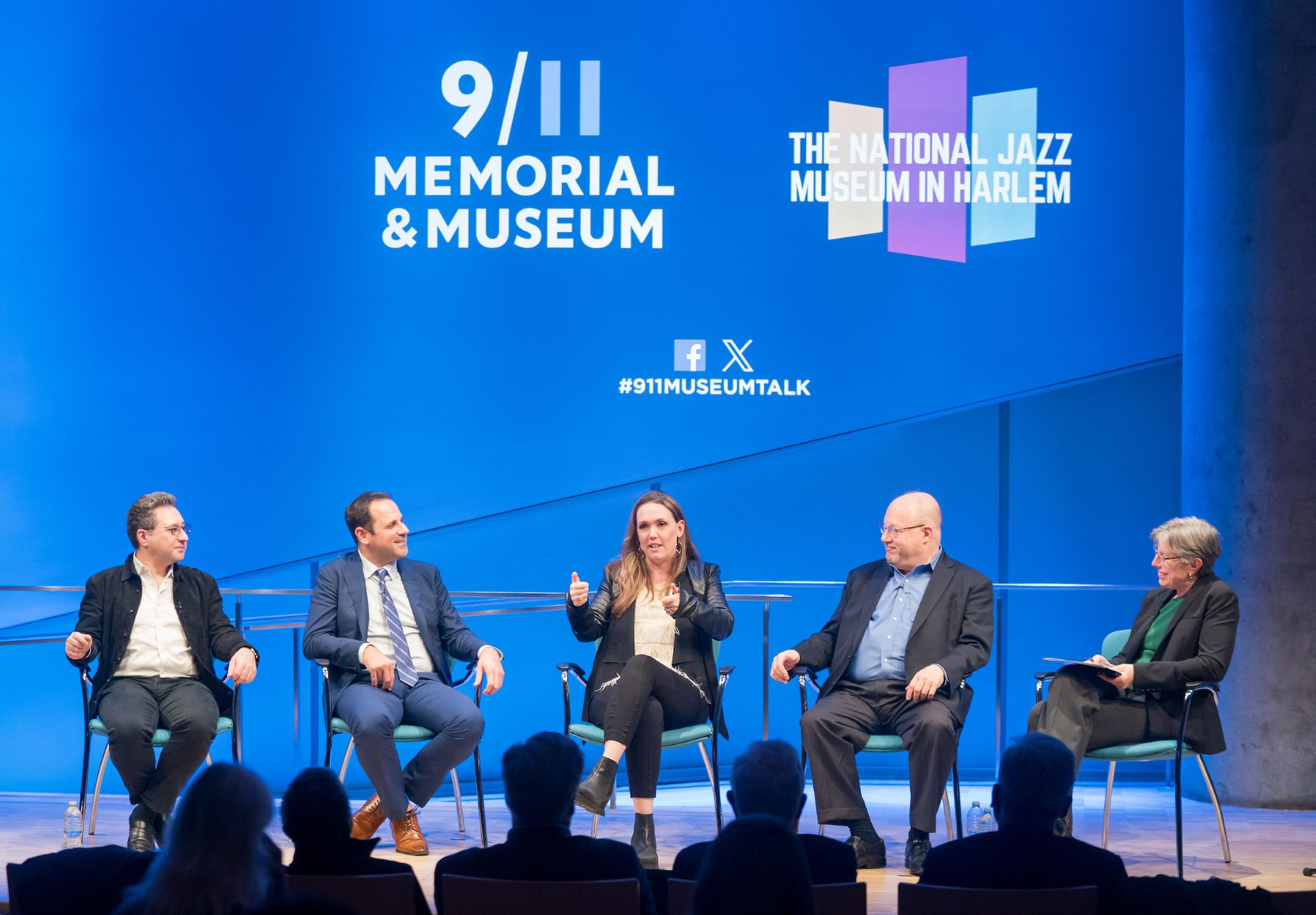 Panelists sit on stage with with Dr. Beth Hillman, President and CEO of the 9/11 Memorial and Museum, front view