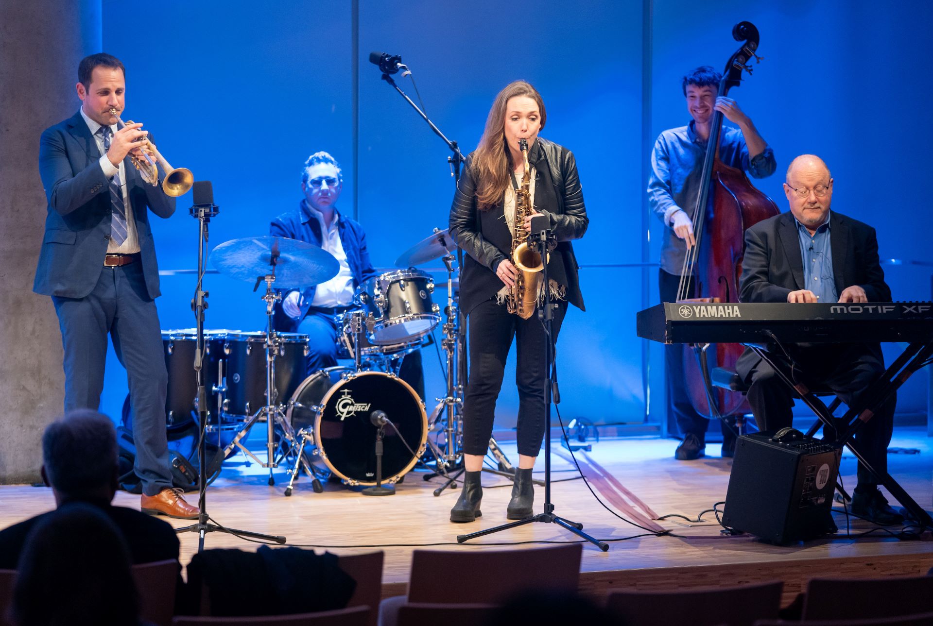 Panelists perform jazz on stage