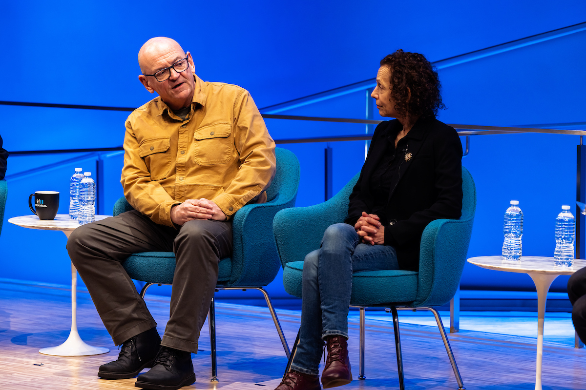 Two panelists face each other and dialogue 