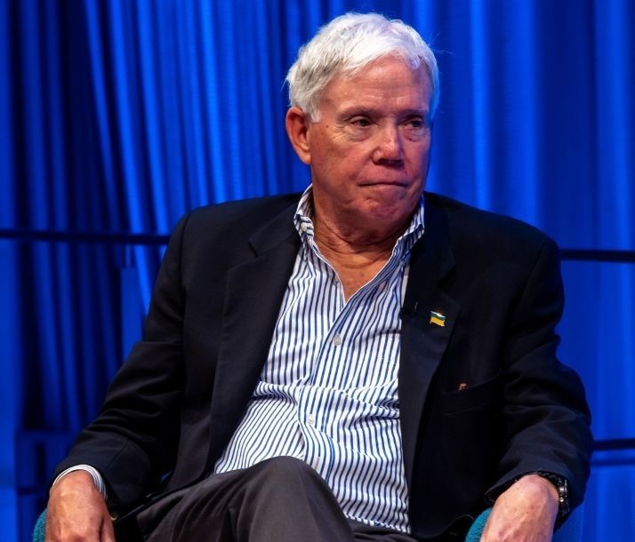 Man on stage listens