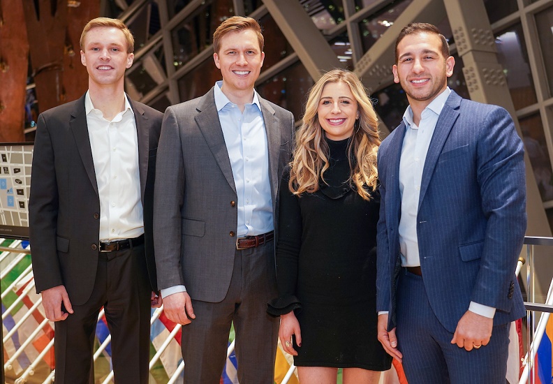 The four members of the Visionary Network leadership pose for a photograph in business-casual attire.