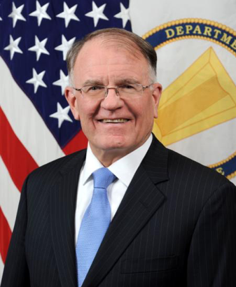 Colonel Mark Lewis poses in a suit and tie for an official photo.