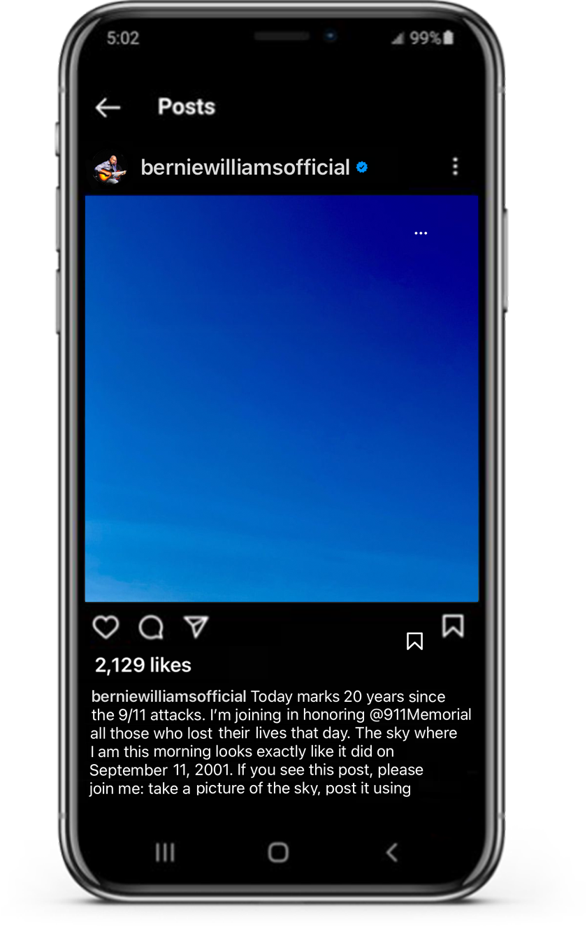 Smartphone shows sample social media post featuring photo of the sky and caption 