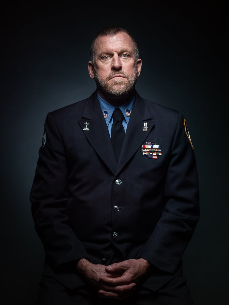 Tim Brown stands somberly in his FDNY dress uniform.