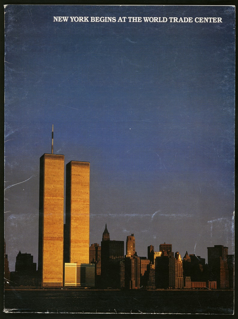 Color photograph of lower Manhattan with Twin Towers glowing with golden sunlight and dominating the grey-blue sky. White text on top reads: "New York Begins at the World Trade Center."