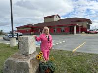SAN the Artist for Project 911up is standing next to the Rockaway 11 memorial sculpure placed at the Gander, Newfoundland in Canada firehouse.