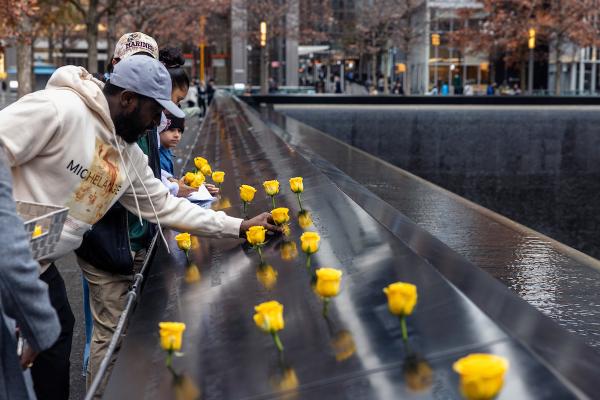 On Veterans Day at the Memorial, volunteers from the veteran organization Team Red, White and Blue, help place more than 250 yellow roses in the names of those who served in the U.S. armed forces. 