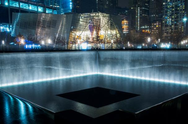Memorial pools lit up at night.
