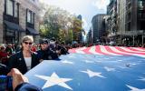 President & CEO Beth Hillman joins Memorial staff and volunteers to carry a massive flag along Fifth Avenue in the NYC Veterans Day Parade. 