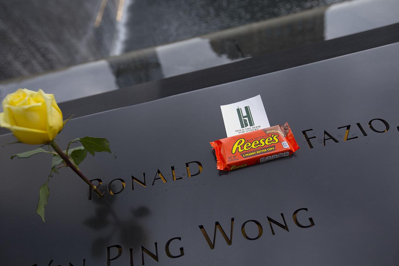 A yellow rose and a package of Reese’s peanut butter cups sits at the name of Ronald Carl Fazio on the Memorial.