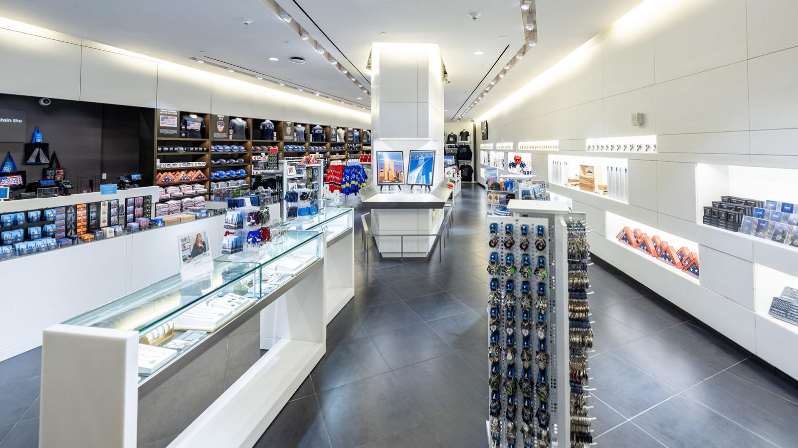 Interior of a gift shop, a long, modern room stocked with many types of 9/11 memorabilia.