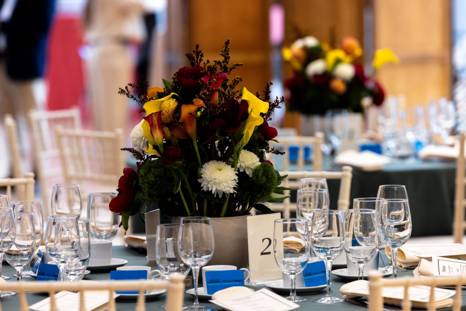 a table is set with crystal and flowers