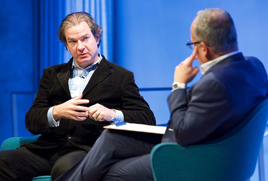 CNN National Security Analyst Peter Bergen speaks onstage at the 9/11 Memorial Museum Auditorium. Clifford Chanin, the executive vice president and deputy director for museum programs, sits beside him with a clipboard on his lap.