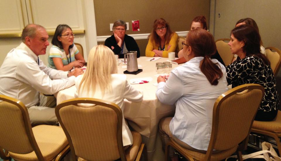 9/11 family members sit around a circular table at the VOICES 14th Annual Day of Remembrance Information Forum.