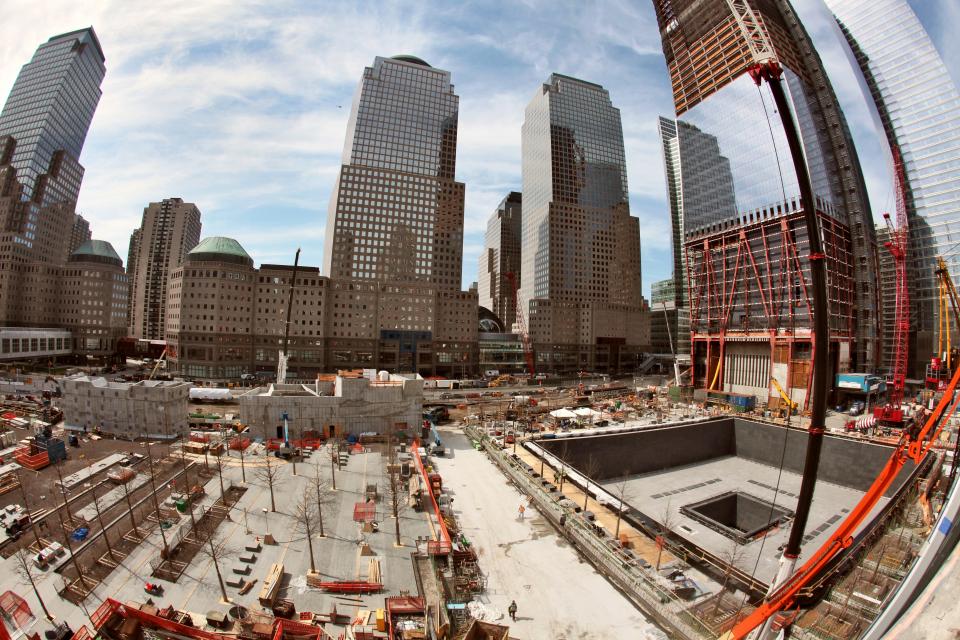 The enormous north pool of the 9/11 Memorial is in the foreground of a looming One World Trade Center. (Joe Woolhead photo) National 9.11 Memorial April 2011 - Credit Joe Woolhead (44).jpg