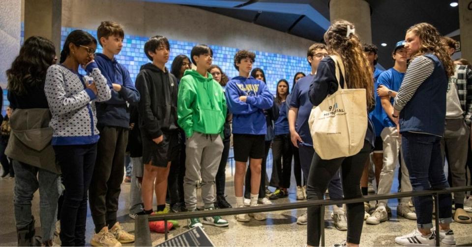 A group of students listens to a tour guide in the Museum