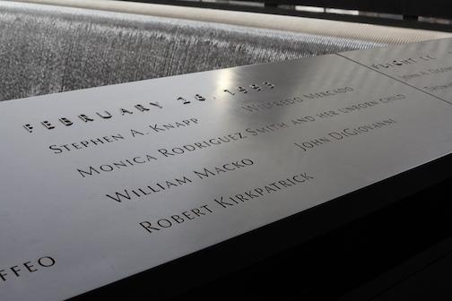 The names of the six victims of the 1993 bombing are seen on a bronze parapet beside a reflecting pool on the 9/11 Memorial.